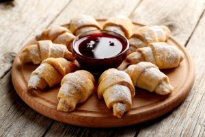 Fresh homemade croissants on a grey wooden table